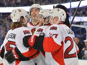 Ottawa Senators left wing Mike Hoffman (58) is congratulated by teammates after scoring the game winning goal in overtime against the Edmonton Oilers at Rexall Place Thursday night. (Steve Alkok-USA TODAY Sports)