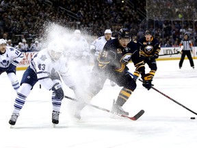 Maple Leafs centre Nazem Kadri (left) gets a face-full of snow as he sticks close to Sabres defenceman Nikita Zadorov at the Niagara Center on Saturday night. In their past 16 games in Buffalo, the Leafs have won just twice now. (USA Today Sports)