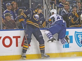 Sabres defenceman Nikita Zadorov checks Maple Leafs’ Roman Polak during last night’s game in Buffalo. (USA TODAY SPORTS)