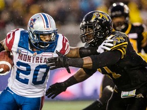 Tyrell Sutton (left) won't play in the East semifinal for the Alouettes. (Mark Blinch/Reuters)