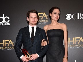 Actor Jack O'Connell, winner of New Hollywood award for "Unbroken," and actress/director Angelina Jolie pose in the press room during the 18th Annual Hollywood Film Awards at The Palladium on Nov. 14, 2014 in Hollywood.   (Jason Merritt/Getty Images/AFP)