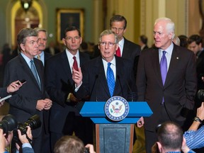 Senate Minority Leader Mitch McConnell (R-KY)(C), speaks with members of the Republican Senate leadership for the 114th Congress on Capitol Hill in Washington November 13, 2014. With McConnell from left are Senators Roy Blunt, (R-MO), Dean Hoeven (R-ND), John Barrasso (R-WY) John Thune (R-SD) and John Cornyn (R-TX).   REUTERS/Joshua Roberts