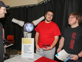 Travis Smith, left, Tyler Arnold and Derek Cornish are all first year students in the Wind Turbine Technician program and volunteered to speak with prospective students at the St. Lawrence College Kingston campus open house held in the Davies Lounge on Saturday November 15, 2014. Julia McKay/Kingston Whig-Standard/QMI Agency