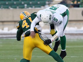Roughriders QB Kerry Joseph takes a big hit from Odell Willis during first-half action Sunday at Commonwealth Stadium. (David Bloom, Edmonton Sun)