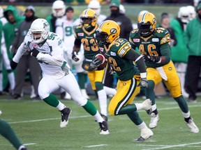 Edmonton’s Kendal Lawrence (32) is chased by Saskatchewan’s Shomari Williams at Commonwealth Stadium, Perry Mah/QMI Agency