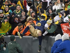 Green Bay Packers linebacker Julius Peppers (56) celebrates with fans after returning an interception 52-yards for a touchdown in the third quarter against the Philadelphia Eagles at Lambeau Field. (Benny Sieu-USA TODAY Sports)