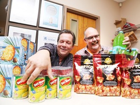 Gino Donato/The Sudbury Star      
Jack Lanctot and Pastor Steve Gudrie show off some of the items they received in their latest truckload of food items.