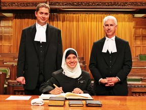 Sarnia native Yasmeen Ibrahim is pictured here at her swearing-in ceremony with Speaker of the House of Commons Andrew Scheer, left, and House clerk David Bosc. The 19-year-old University of Ottawa student served as a page in the House of Commons last school year. SUBMITTED PHOTO