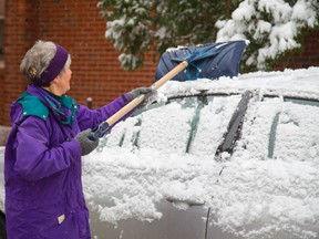 Londoners awoke Monday to a familiar task as wet snow covered their cars for the first time this fall. (MIKE HENSEN, The London Free Press)