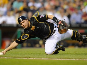 Pittsburgh Pirates catcher Russell Martin (55) fields an infield hit against the St. Louis Cardinals in the third inning of their National League MLB baseball game in Pittsburgh, Pennsylvania July 31, 2013. (REUTERS/David DeNoma)