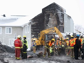 Emergency workers dig through the remains on the site of the Residence du Havre in L'Isle Verte, Quebec, January 28, 2014. REUTERS/Mathieu Belanger