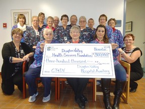 Volunteers with the Drayton Valley Hospital Auxiliary present representatives from the Drayton Valley Health Services Foundation with a donation for $300,000 collected through community purchases at the organization’s thrift store and hospital gift shop. Funds will be used toward the health foundations purchase of a CT scanner for the local hospital.