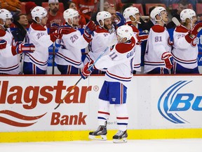 Montreal Canadiens forward Brendan Gallagher (11) receives congratulations from teammates after scoring in the third period against the Detroit Red Wings at Joe Louis Arena. (Rick Osentoski/USA TODAY Sports)