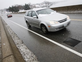 Over the past couple of weeks, motorists commuting across the Bay of Quinte on the Norris Whitney Bridge between Belleville, Ont. and Rosmore, Ont. have been driving over dozens of black squares like this one photographed on Monday, Nov. 17, 2014. As part of an ongoing road condition survey, the Ministry of Transportation took some cores of the deck concrete on both lanes of the bridge and sent them to a laboratory for further testing. - JEROME LESSARD/THE INTELLIGENCER/QMI AGENCY