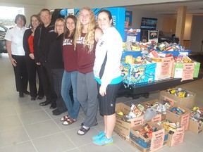 A large can drive at Wallaceburg District Secondary School, and at Progressive Ford, provided a large donation to Wallaceburg's Salvation Army Food Bank. WDSS teacher Kathy Collins led a class challenge at the school, with each homeroom classroom collecting cans. The senior's girl basketball team also organized a can drive at the school by hosting a number of events. Accepting the cans are, from left to right, Salvation Army's Stephanie Watkinson and Gerri St. Pierre. Presenting the cans are Progressive Ford's Jered Sweet and Terri Bechard, as well as WDSS basketball players Alyssa Lucier, Brett Fischer and Tartan girls basketball coach Janine Day. Progressive Ford will be hosting a toy drive during the month of November, and will give out a ballot for six Sarnia Sting tickets when someone donates a toy. Additionally, Progressive Ford will donate $100 to the Salvation Army for every car they sell in November.