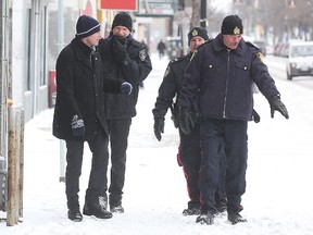 Mayor Brian Bowman (left) walks the beat on Selkirk Avenue with Peter de Graaf, the city's manager of community bylaw enforcement, and police Sgts. Dave Tyndale and Mark Pruden. (Brian Donogh/Winnipeg Sun)