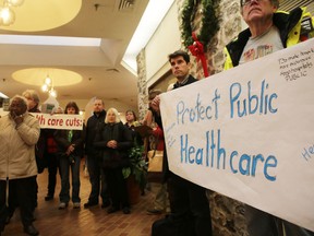 Supporters of the Kingston Health Coalition gather at a rally at the office of Kingston and the Islands MPP Sophie Kiwala on Monday afternoon. The group was protesting health care cuts by the provincial government. (Elliot Ferguson/The Whig-Standard)