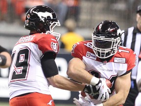 Calgary Stampeders’ quarterback Bo Levi Mitchell passes off the football to Matt Walter during the second half of CFL game against the BC Lions at BC Place in Vancouver, B.C. on November 7, 2014. (Carmine Marinelli/QMI Agency)
