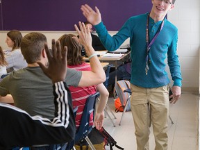 Jeremy Grace high-fives classmates at Central secondary school in London, Ontario on Monday, November 17, 2014. (DEREK RUTTAN, The London Free Press)