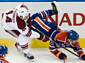 Edmonton's Andrew Ference gets upended by Arizona's B.J. Crombeen during Sunday's game at Rexall Place (Codie McLachlan, Edmonton Sun).