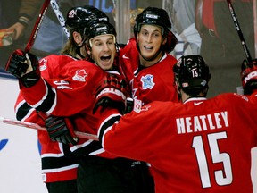 Canada's Ryan Smyth celebrates scoring his team's third goal with teammates Vincent Lecavalier and Dany Heatley during second period play in their World Cup of Hockey quarterfinal game in Toronto on September 8, 2004. (REUTERS/Shaun Best)