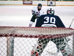 Chase Snider sizes up the South Country goaltender during his second period penalty shot. Snider would miss the penalty shot but score minutes later as the Huskies topped the Sabres 12-1. Greg Cowan photo/QMI Agency.