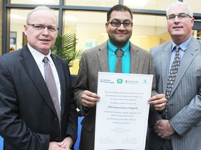 The heads of the local Catholic and public school boards stand with Lambton County's medical officer of health, showing off a signed form that signals the start of the Alternate Choices program in Sarnia-Lambton. High schools in Lambton County are taking part in the new tobacco education program for students. From left are Dan Parr, Dr. Sudit Ranade and Jim Costello with the form outside the St. Patrick's high school office. TYLER KULA/ THE OBSERVER/ QMI AGENCY