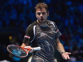 Stan Wawrinka of Switzerland gestures towards the coaches and family box of Roger Federer of Switzerland, during their semifinal tennis match at the ATP World Tour Finals at the O2 Arena in London November 15, 2014. (REUTERS)
