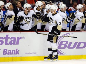 Pittsburgh Penguins defenseman Olli Maatta (3) receives congratulations from teammates after scoring in the first period against the Detroit Red Wings at Joe Louis Arena on Oct 23, 2014 in Detroit, MI, USA. (Rick Osentoski/USA TODAY Sports)
