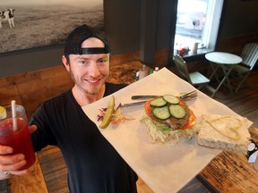 Boon Burger chef Matt Underhill displays some of their products in Winnipeg, Man. Tuesday November 18, 2014. After being stuck with a bogus order, the staff at the restaurant gave the food to needy people.(Brian Donogh/Winnipeg Sun/QMI Agency)