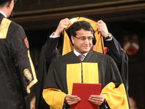 Dr. Shaf Keshavjee, a thoracic surgeon and director of the Toronto Lung Transplant Program, is hooded as he receives an honorary degree from Queen's University during its fall convocation at Grant Hall. TUES., NOV. 18, 2014 KINGSTON, ONT. MICHAEL LEA THE WHIG STANDARD QMI AGENCY