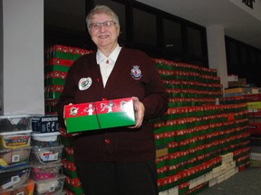 Sandy Kellestine, logistics coordinator for the Operation Christmas Child campaign in St. Thomas and Elgin, stands with hundreds of shoeboxes collected for this year's campaign at the Salvation Army Citadel in St. Thomas. The boxes are filled with school supplies, hygiene products and toys and will be sent to Central and South America, Africa and Ukraine. (Ben Forrest, Times-Journal)