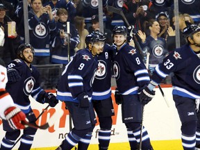 The Jets celebrate one of their second-period goals in a win over the New Jersey Devils on Tuesday.