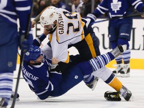 Maple Leafs captain Dion Phaneuf is knocked to the ice during a fight with the Nashville Predators’ Paul Gaustad in the second period at the Air Canada Centre last night. (Stan Behal/Toronto Sun)