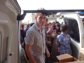 Abdul-Rahman (Peter) Kassig is pictured making a food delivery to refugees in Lebanon’s Bekaa Valley in this May 2013 handout photo. Islamic State militants said in a video November 16, 2014 they had beheaded U.S. hostage aid worker Kassig and warned the United States they would kill other U.S. citizens. (REUTERS/Kassig Family/Handout via Reuters)