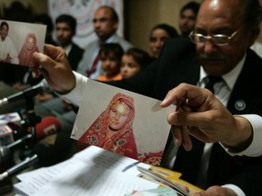 Mansoor-ur-Rehman Afridi, the lawyer for Khalida Bibi who is sister of the late Farzana Iqbal, holds a picture which according to Bibi is of Farzana's first marriage with her cousin Mazhar Iqbal during a news conference in Lahore May 31, 2014. REUTERS/Mani Rana