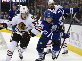 Leafs' Mike Santorelli in a foot race with Trevor van Riemsdyk. Toronto Maple Leafs vs the Chicago Black hawks at the Air Canada Centre in Toronto on Saturday November 1, 2014. Craig Robertson/QMI Agency