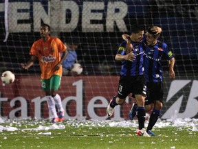 Colombian soccer team Envigado, seen in action against Liverpool of Uruguary in the Copa Sudamericana in 2012, has been accused of laundering drug money. (REUTERS/Andres Stapff)