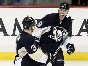Pittsburgh Penguins defenceman Olli Maatta (3) and  forward Pascal Dupuis (9) celebrate after a goal against the New Jersey Devils at the CONSOL Energy Center. (Charles LeClaire/USA TODAY Sports)