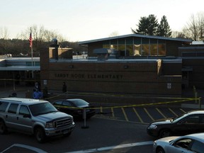Police secure the scene at Sandy Hook Elementary School in Newtown, Connecticut, in this evidence photo released by the Connecticut State Police, December 27, 2013. Connecticut state police released a trove of documents and video on Friday tied to their investigation of the massacre at Sandy Hook Elementary School last year that killed 20 children and six adults. REUTERS/Connecticut State Police/Handout via Reuters