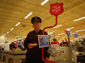 Salvation Army volunteer Bob Barrett stands with a Christmas kettle at the Real Canadian Superstore in St. Thomas in December last year. The Salvation Army is launching its 2014 Christmas Kettle Campaign on Saturday. File photo