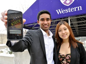 Western University students Shehan Wijeyagoonewardane (left) and Kelly He, part of a cross-country team of students behind the new iOS app Cab Share Canada, display the new app in London Ont. Nov. 20, 2014. CHRIS MONTANINI\LONDONER\QMI AGENCY