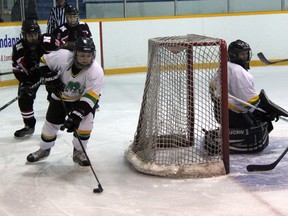 St. Patrick's goalie Naomi Dubs watches teammate Meg Blythe circle the net with the puck as Northern's Ashley Williams, left, and Naomi Parsons give chase. Northern won the high school girls hockey game 7-2 Wednesday at Clearwater Arena. (TERRY BRIDGE, The Observer)