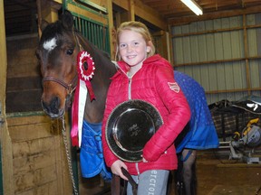 Emily Burton of the Port Stanley area stands with her pony Little Dickens and a silver plate and ribbon she won recently at the Royal Winter Fair in Toronto. (Ben Forrest, Times-Journal)