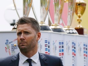 Australian cricket team captain Michael Clarke is pictured alongside Cricket World Cup trophies that have been previously won by Australia and a perpetual trophy during an event to mark the 100-day countdown to the 2015 Cricket World Cup in Sydney on Nov. 6, 2014. New Zealand and Australia will co-host the Cricket World Cup in 14 cities beginning Feb. 14. (JASON REED/Reuters)