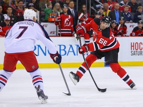 New Jersey Devils right wing Jaromir Jagr (68) shoots the puck while being defended by Columbus Blue Jackets defenceman Jack Johnson (7) during the second period at Prudential Center on Nov. 1, 2014 in Newark, New Jersey. (Ed Mulholland-USA TODAY Sports)