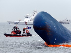 Rescue boats sail around the South Korean passenger ship "Sewol" which sank, during their rescue operation in the sea off Jindo, in this April 17, 2014 file photograph. REUTERS/Kim Kyung-Hoon