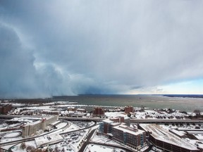 Storm clouds and snow blows off Lake Erie in Buffalo, New York, November 18, 2014. (REUTERS)