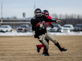 Kelsey Wilchowy, Whitecourt Cats, deeks out Sylvan Lake Lakers defence, during their Tier III Alberta high school football northern divisional finals game at Graham Acres Park in Whitecourt, Alta. on Saturday, Nov. 15, 2014. The Whitecourt Cats defeated the Sylvan Lake Lakers 28 - 20, which earned them a spot in the provincial final on Nov. 21.
Adam Dietrich | Whitecourt Star
