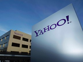 A Yahoo logo is pictured in front of a building in Rolle, 30 km (19 miles) east of Geneva, in this file picture taken December 12, 2012.  Yahoo Inc's revenue rose 1 percent in the third quarter, even as the company's online display advertising business continued to decline.    REUTERS/Denis Balibouse/Files